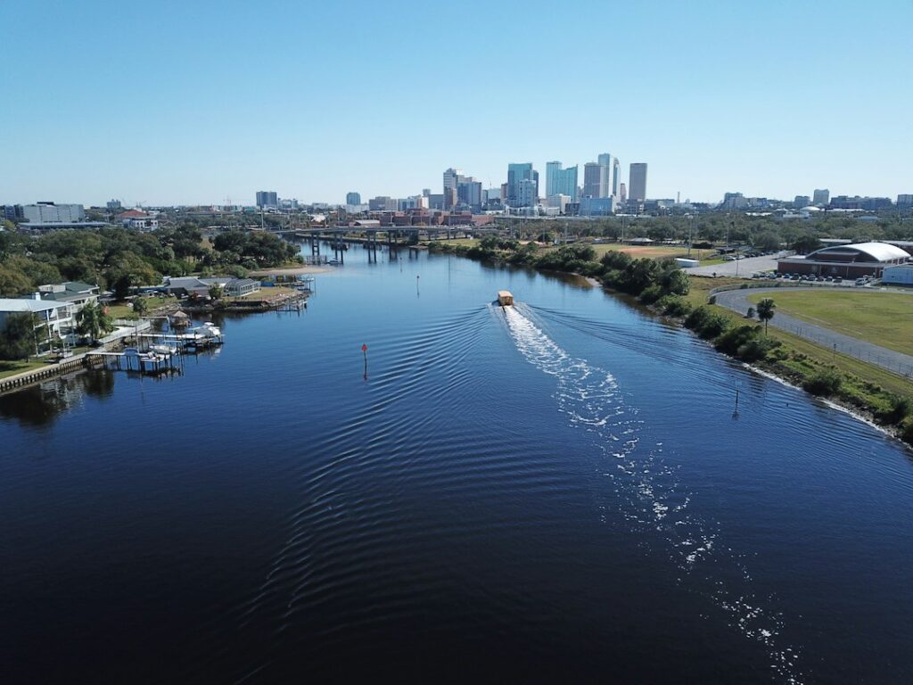 Aerial view of downtown Tampa, Florida, with a water taxi on the Hillsborough River