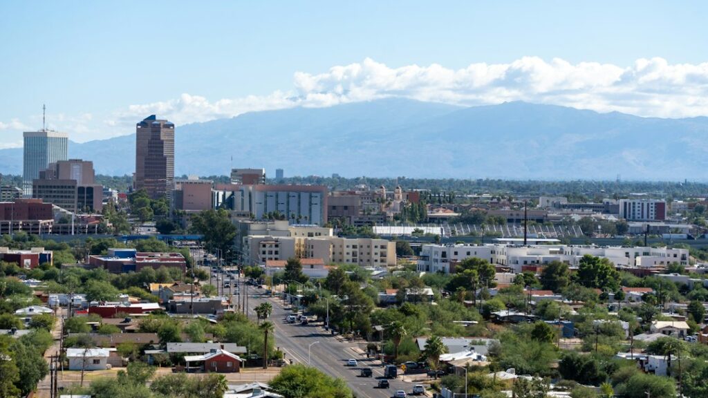 Wide view of a city spread across a valley with mountains rising in the background