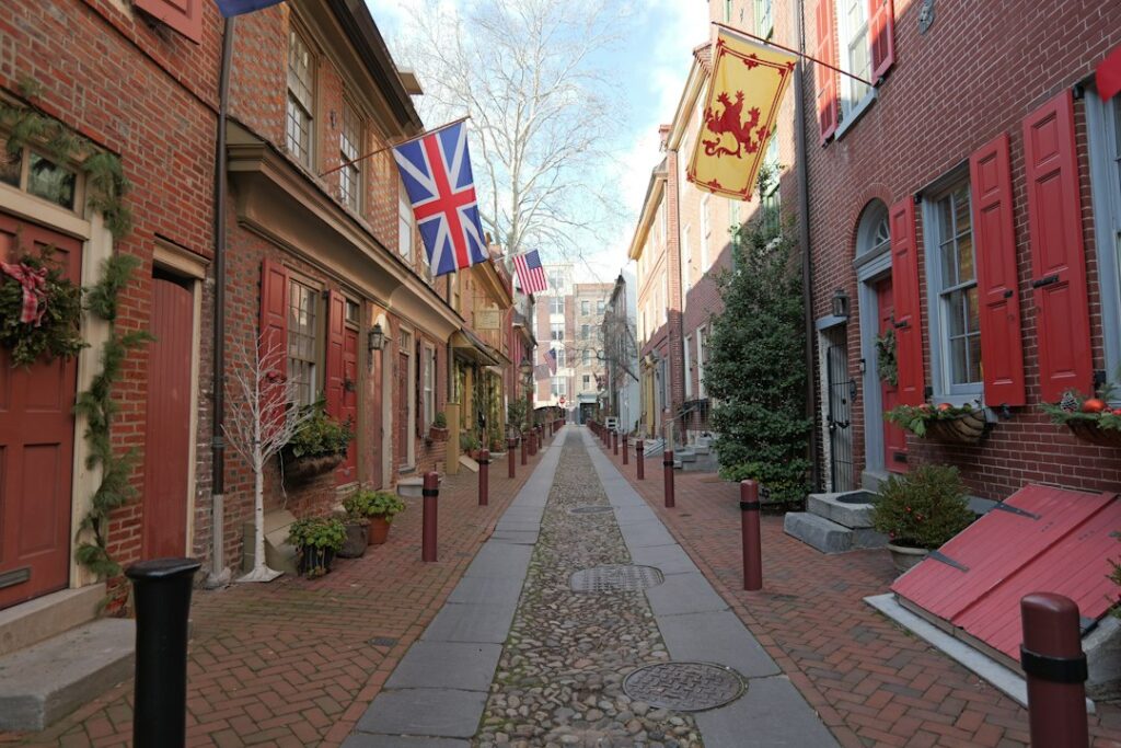 Narrow street lined with older red brick residential buildings on both sides