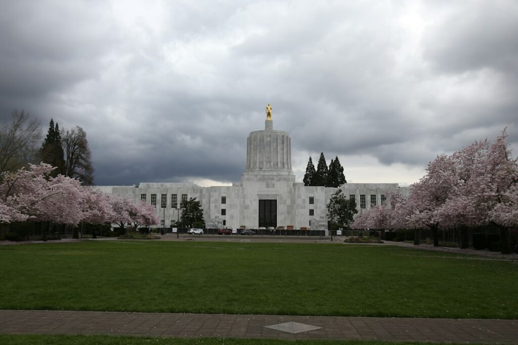 Oregon State Capitol building in downtown Salem framed by spring blossoms