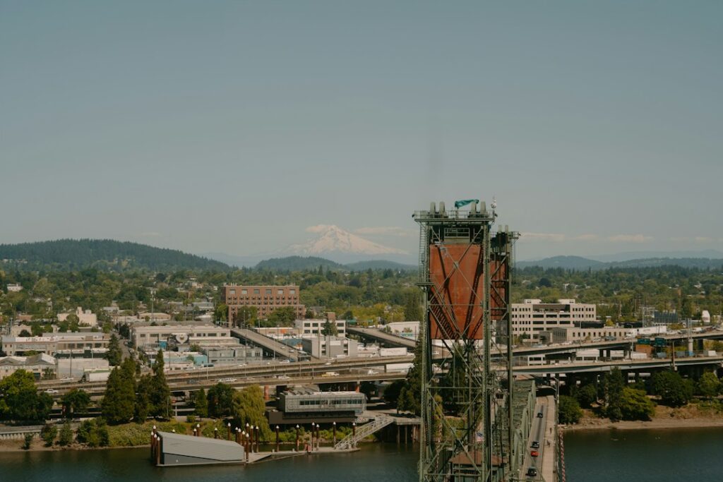 Portland, Oregon riverfront with a bridge, city buildings and Mount Hood in the distance