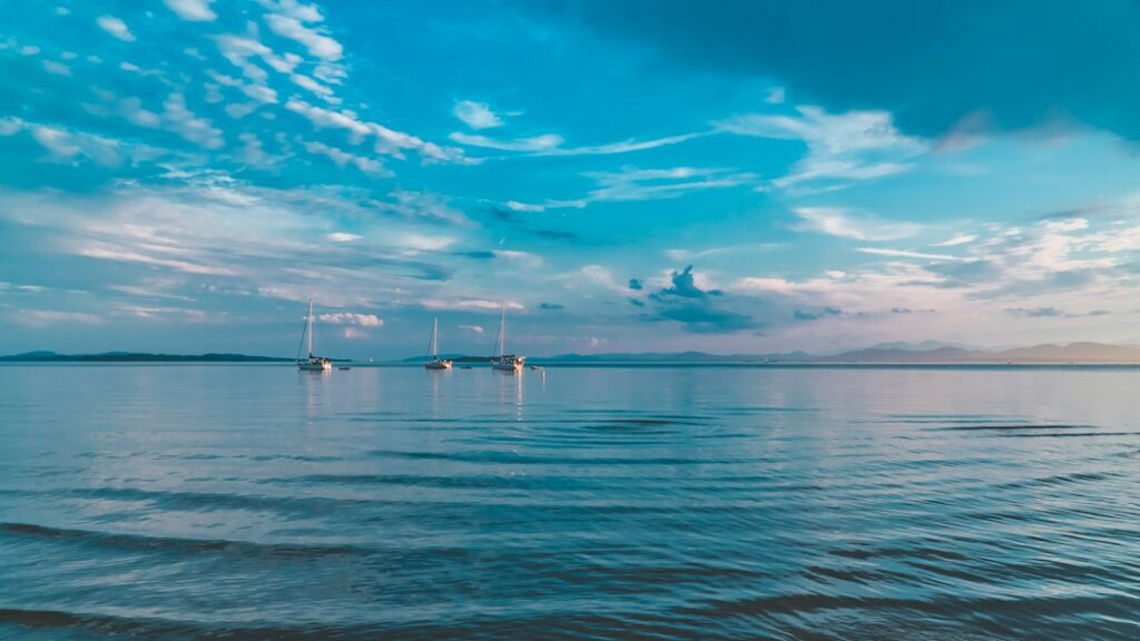 Sunset over the Lake Champlain shoreline seen from a beach in Burlington, Vermont