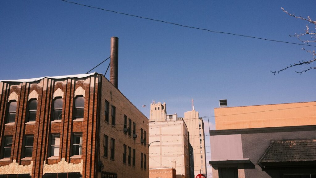 Tall multistory brick building beside a road, the kind of older property assessors value annually